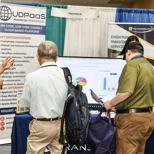 Men and women visiting a booth at an expo event