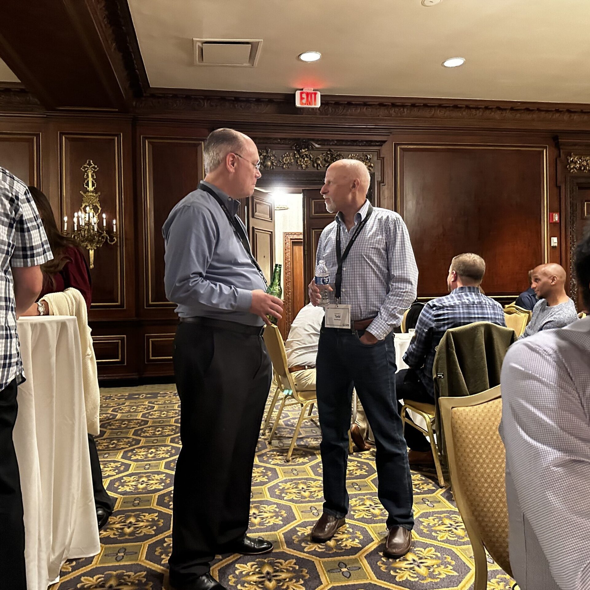 Two men talking at a conference