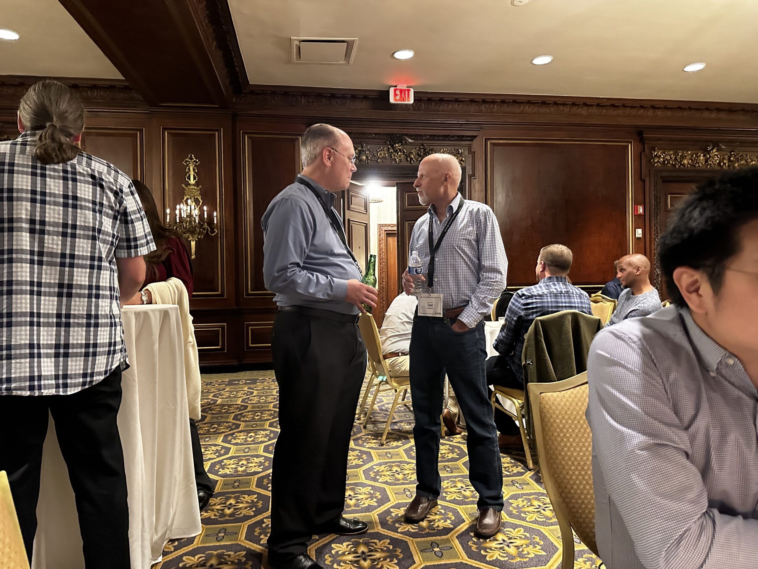 Two men talking at a conference